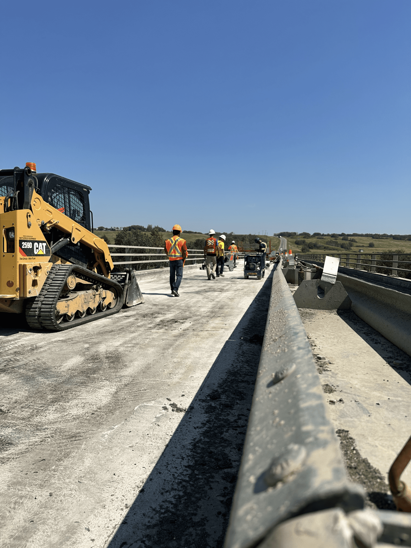 a construction site on a bridge with a group of workers diligently working on the project